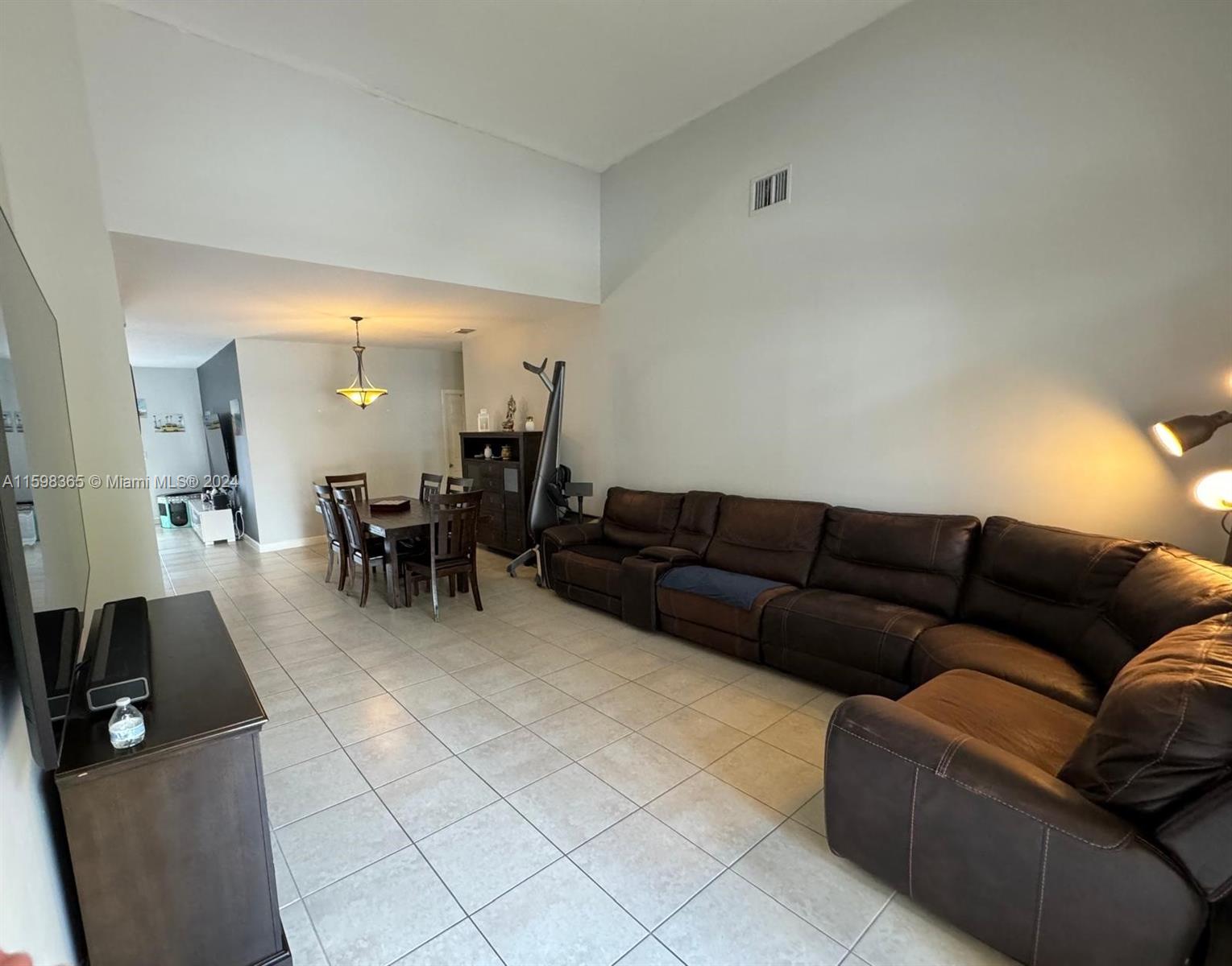 2841 Northeast 41st Place Homestead, FL 33033 - Photo 3 of 71 a living room with furniture and a dining table with kitchen view
