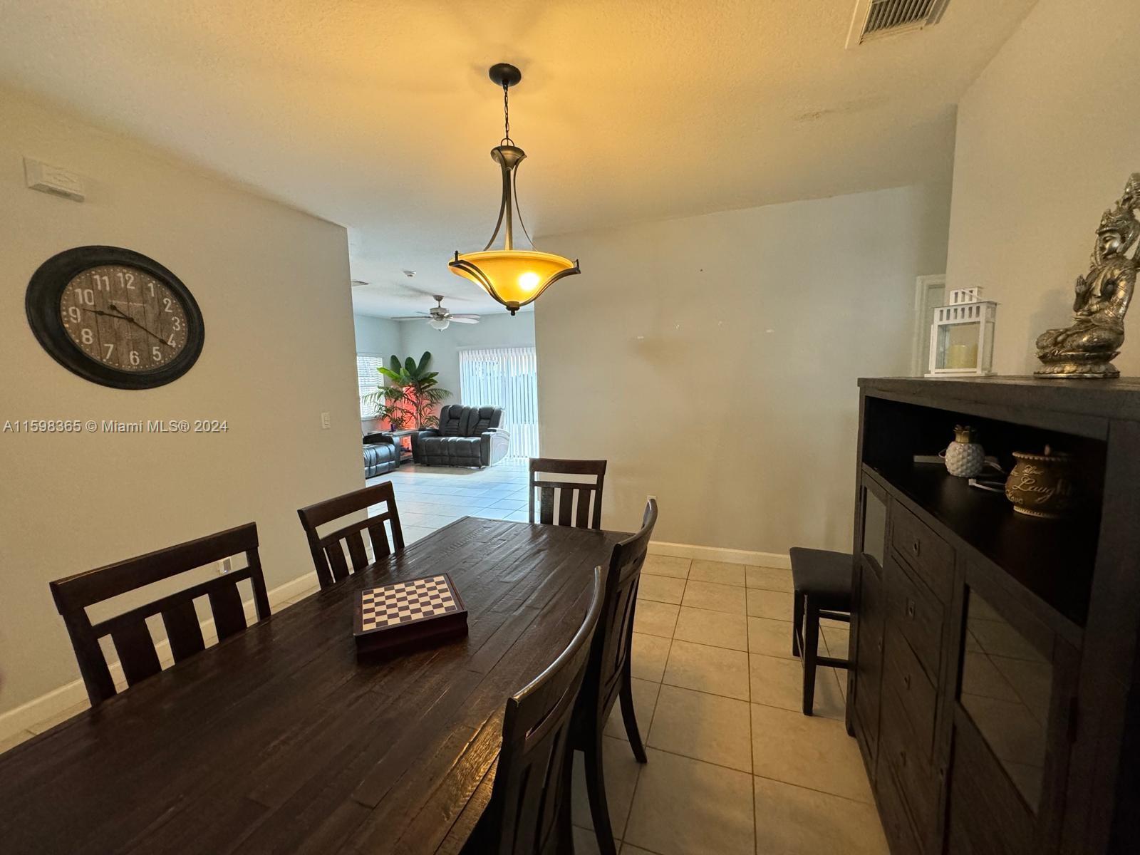 2841 Northeast 41st Place Homestead, FL 33033 - Photo 4 of 71 a view of a dining room with furniture and wooden floor