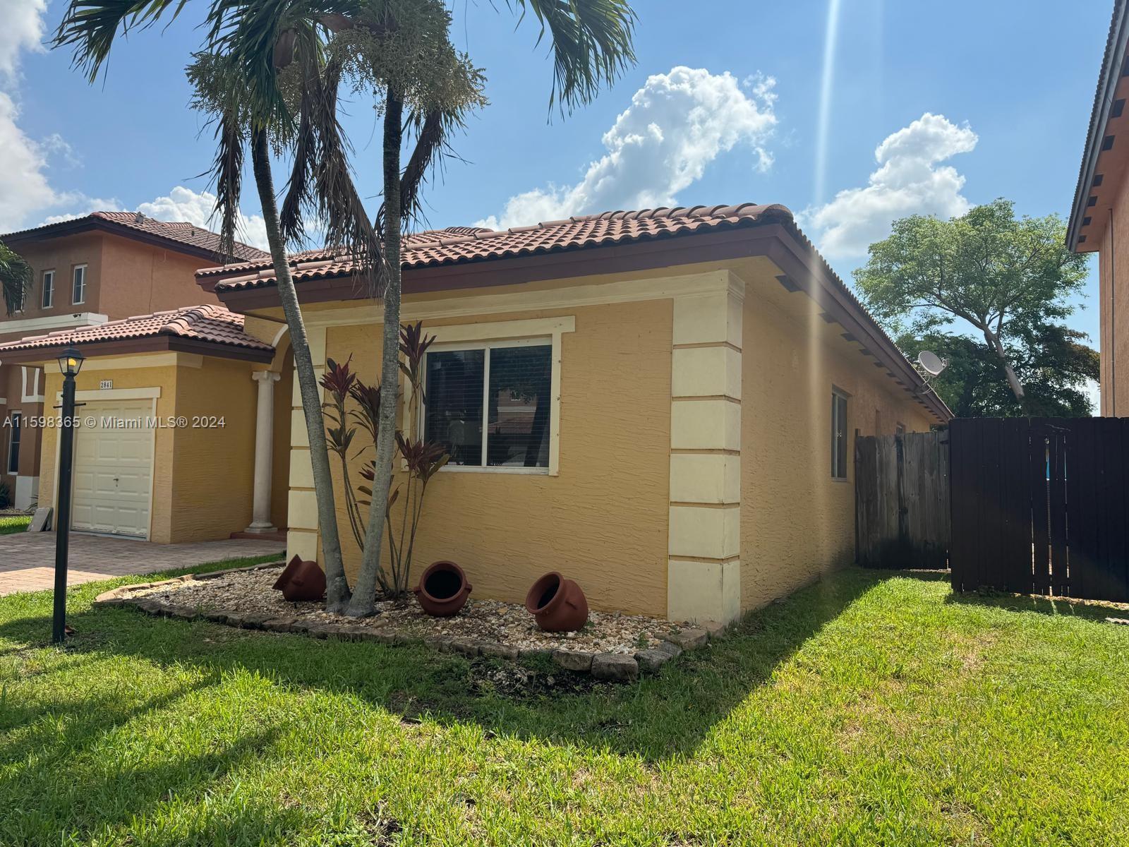 2841 Northeast 41st Place Homestead, FL 33033 - Photo 46 of 71 a front view of a house with garden