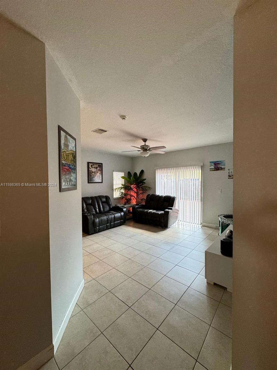 2841 Northeast 41st Place Homestead, FL 33033 - Photo 5 of 71 a living room with furniture and a flat screen tv