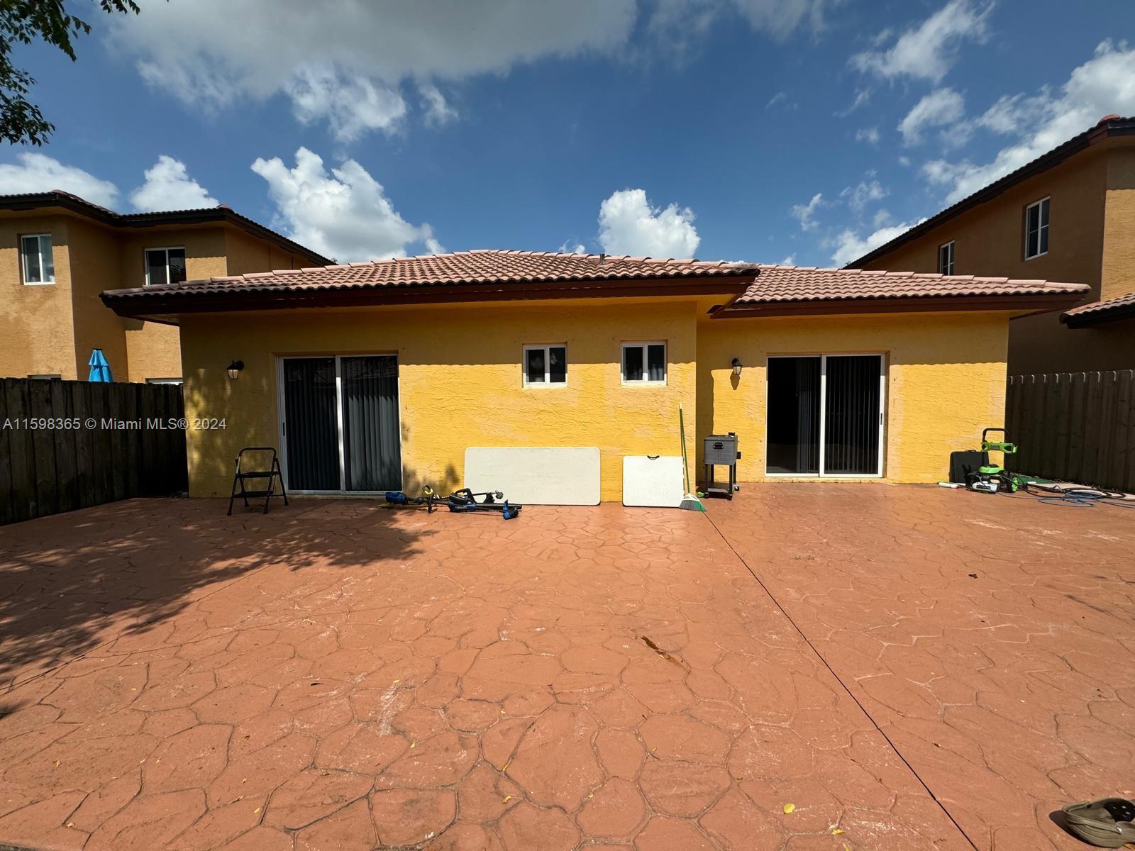 2841 Northeast 41st Place Homestead, FL 33033 - Photo 51 of 71 a front view of a house with a yard and garage