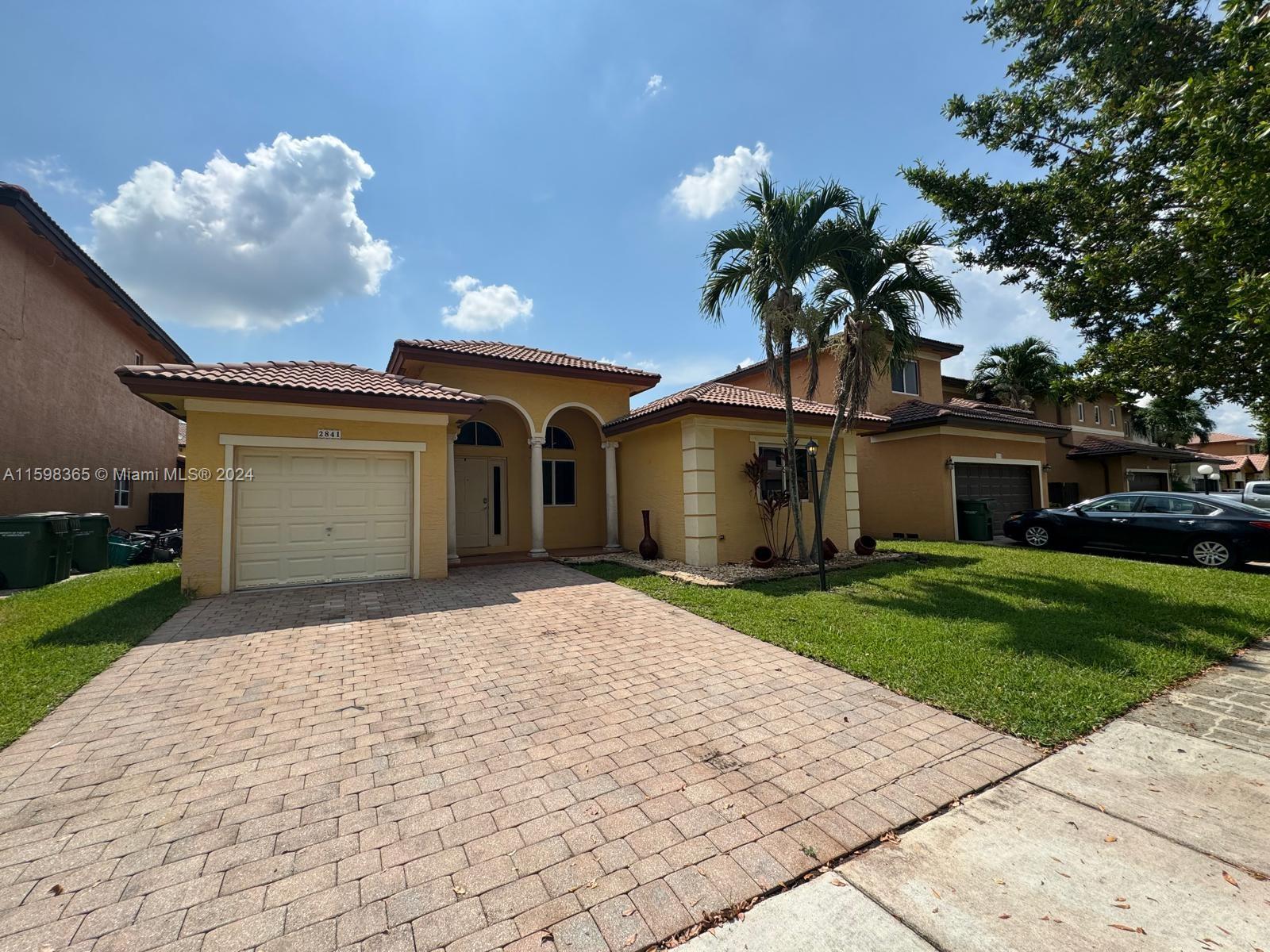 2841 Northeast 41st Place Homestead, FL 33033 - Photo 54 of 71 a front view of a house with a garden and entryway