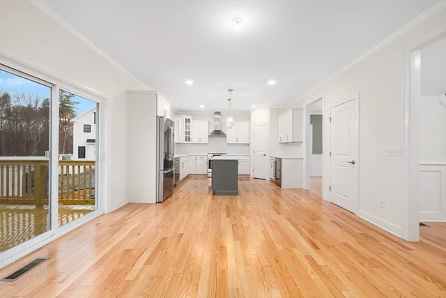 a big room with wooden floor and windows