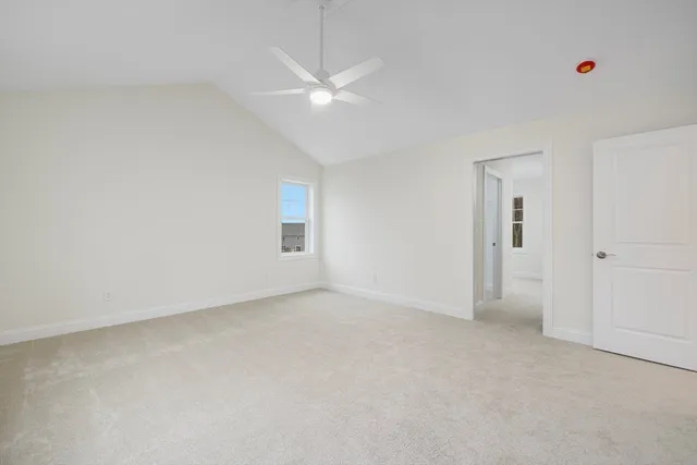 an empty room with fan and windows