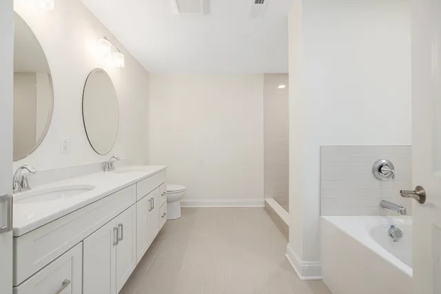 a bathroom with a double vanity sink and a mirror