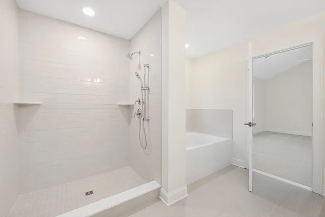 a bathroom with a bathtub and a shower
