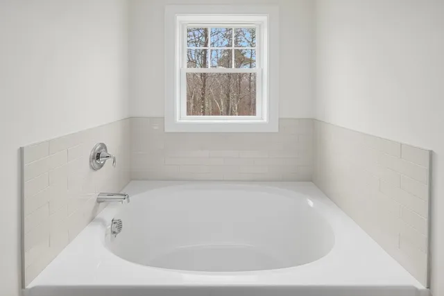 a white bath tub sitting in a bathroom