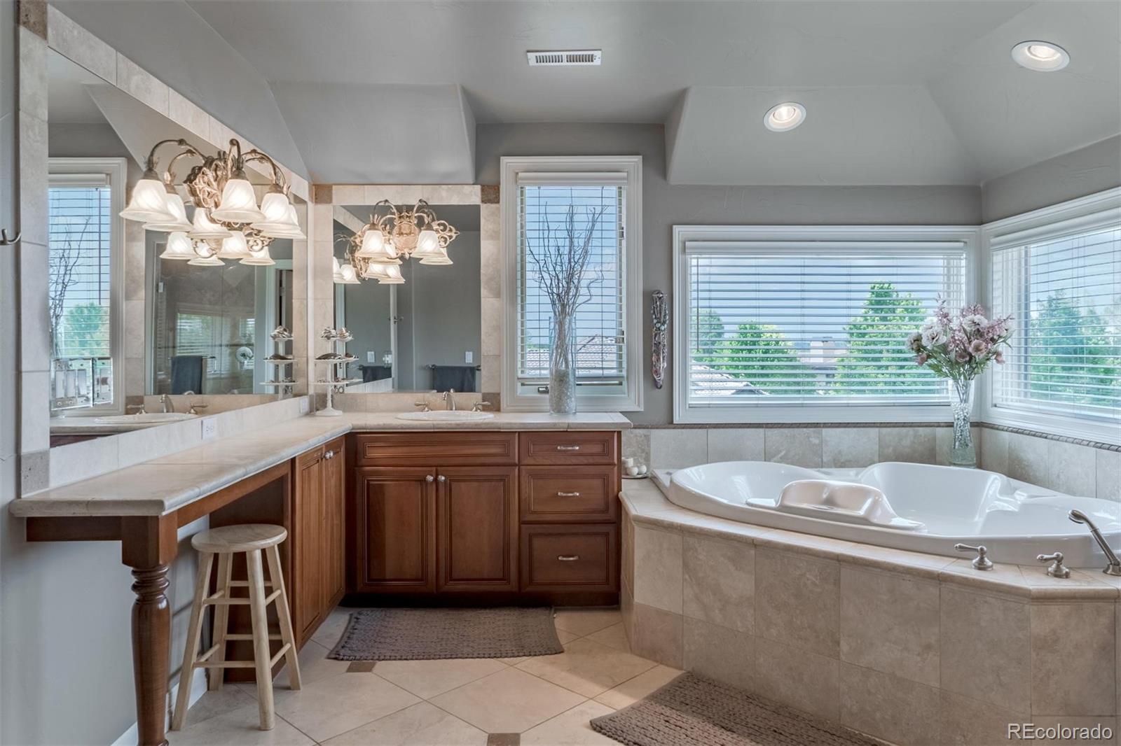 2671 Ranch Reserve Ridge Westminster, CO 80234 - Photo 14 of 35 a spacious bathroom with a granite countertop tub sink and mirror