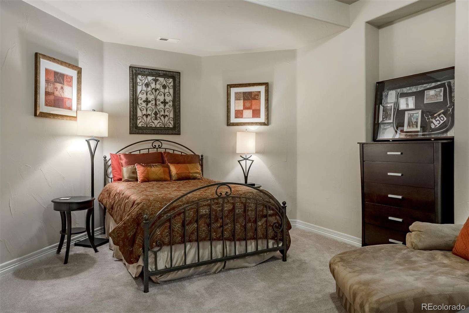 2671 Ranch Reserve Ridge Westminster, CO 80234 - Photo 19 of 35 a bedroom with a bed and cabinet