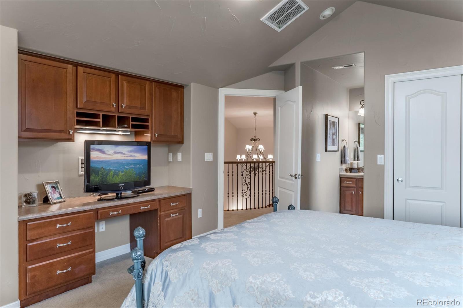 2671 Ranch Reserve Ridge Westminster, CO 80234 - Photo 23 of 35 a bedroom with a bed and a flat screen tv