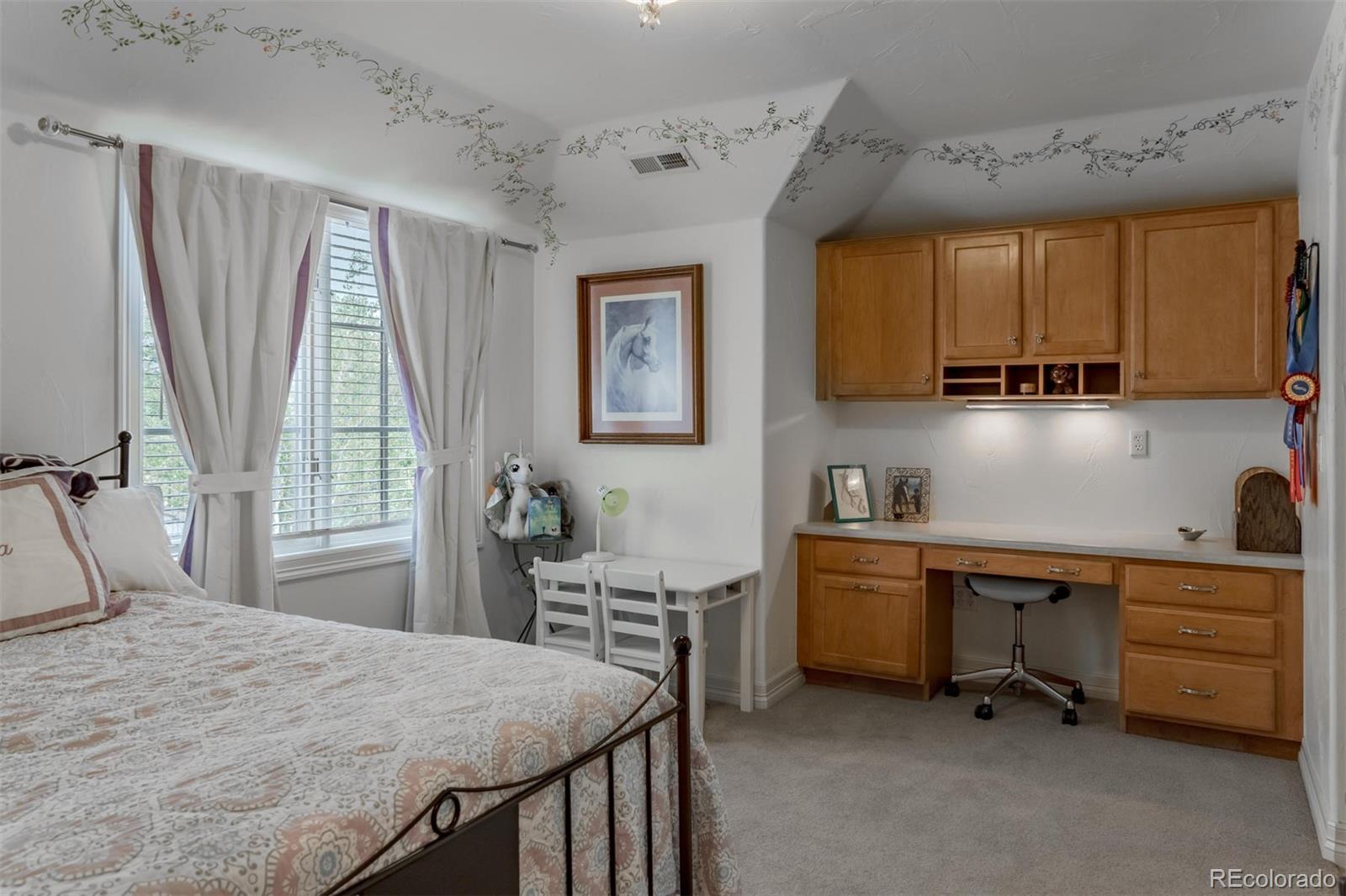 2671 Ranch Reserve Ridge Westminster, CO 80234 - Photo 24 of 35 a bedroom with a bed and a desk