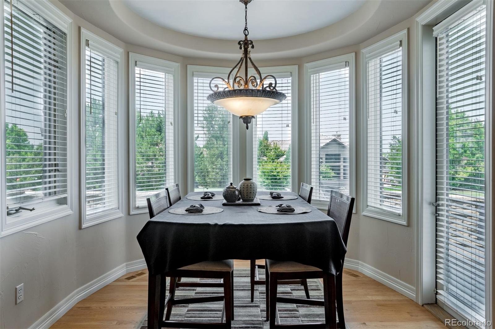 2671 Ranch Reserve Ridge Westminster, CO 80234 - Photo 10 of 35 a dining room with furniture a chandelier and wooden floor
