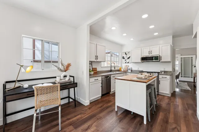 a kitchen with a stove a sink and a refrigerator