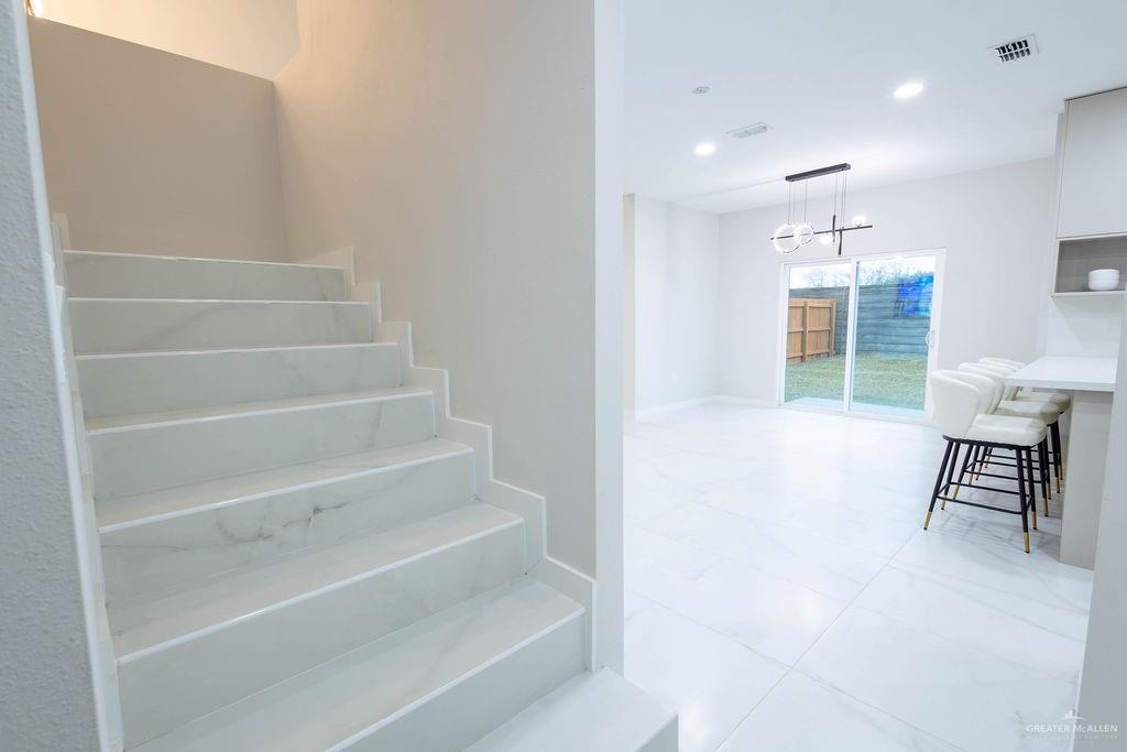 2209 Corales Street Mission, TX 78573 - Photo 14 of 30 a view of kitchen and hallway with stairs