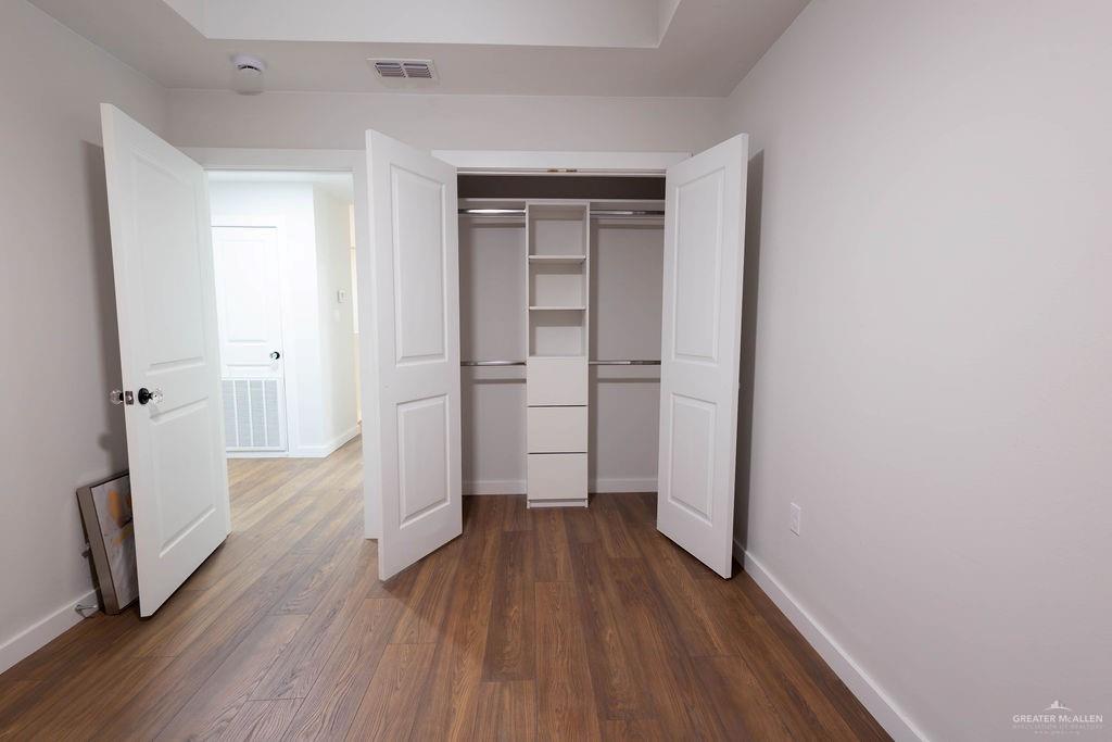 2209 Corales Street Mission, TX 78573 - Photo 22 of 30 a view of a hallway with wooden floor and a hallway