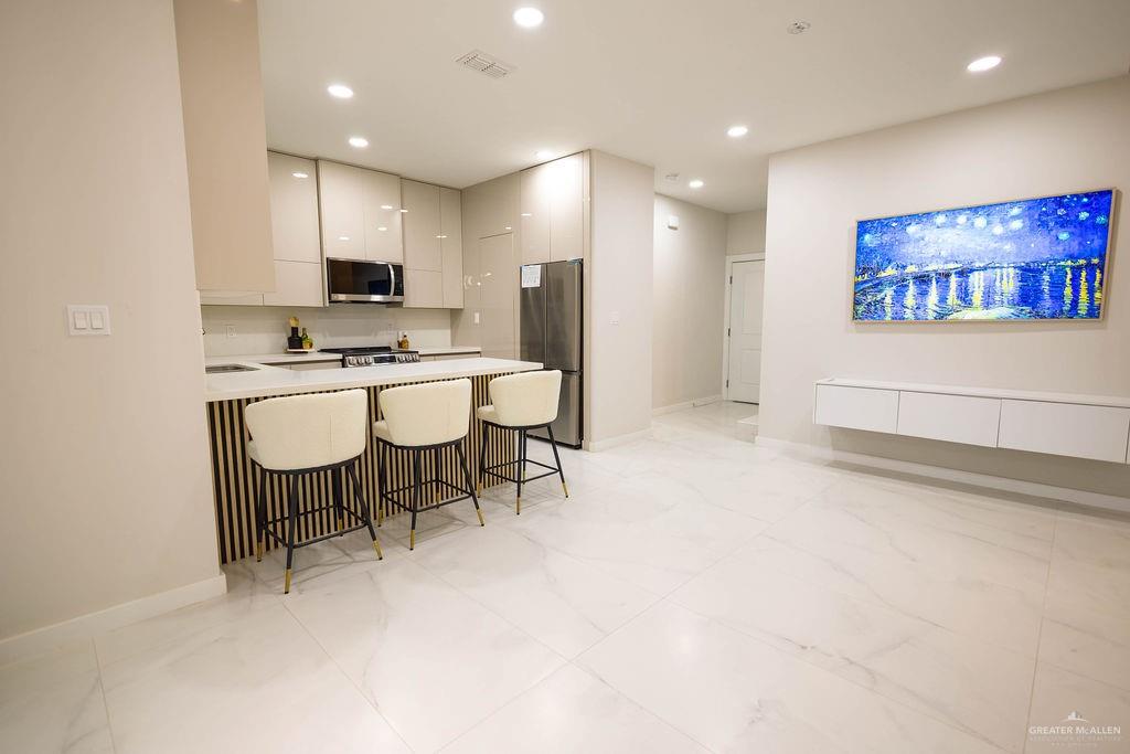 2209 Corales Street Mission, TX 78573 - Photo 7 of 30 a large kitchen with a table and chairs