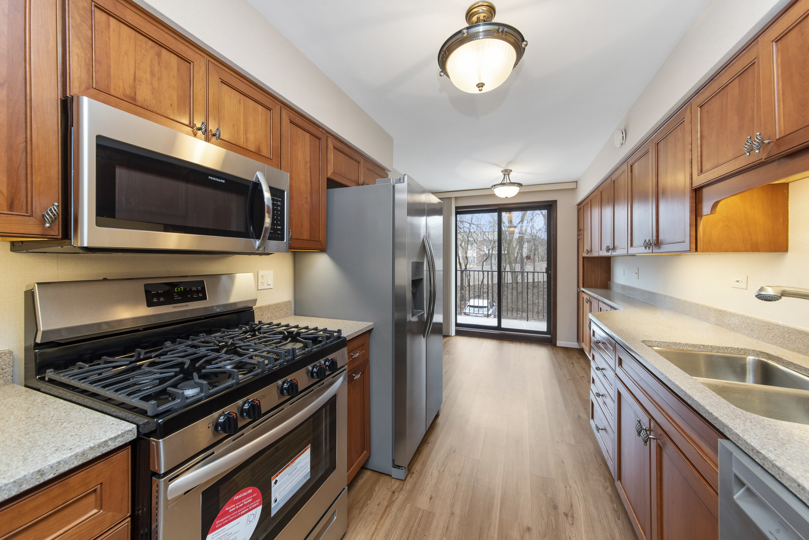 1-s150 Spring Road, Unit 2E Oak Brook, IL 60181 - Photo 3 of 22 a kitchen with stainless steel appliances granite countertop a stove and a microwave