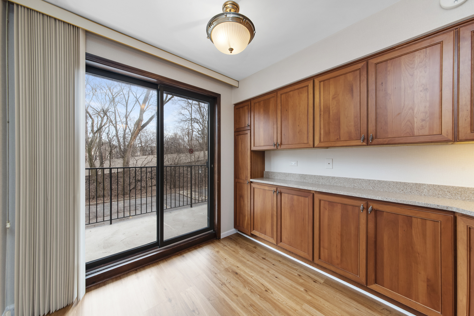 1-s150 Spring Road, Unit 2E Oak Brook, IL 60181 - Photo 6 of 22 a view of a kitchen with wooden floor and more cabinets