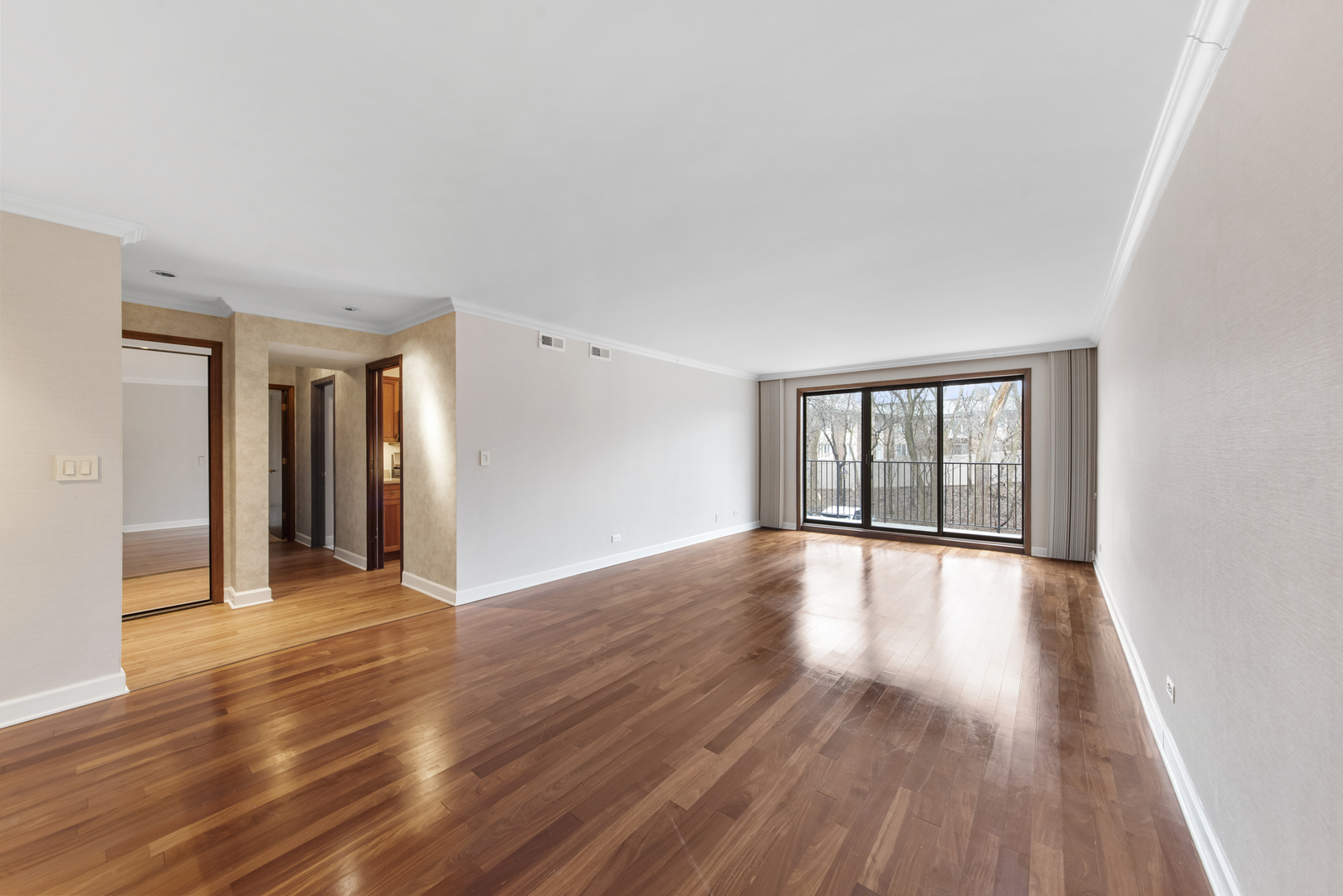 1-s150 Spring Road, Unit 2E Oak Brook, IL 60181 - Photo 7 of 22 a view of an empty room with wooden floor and a window