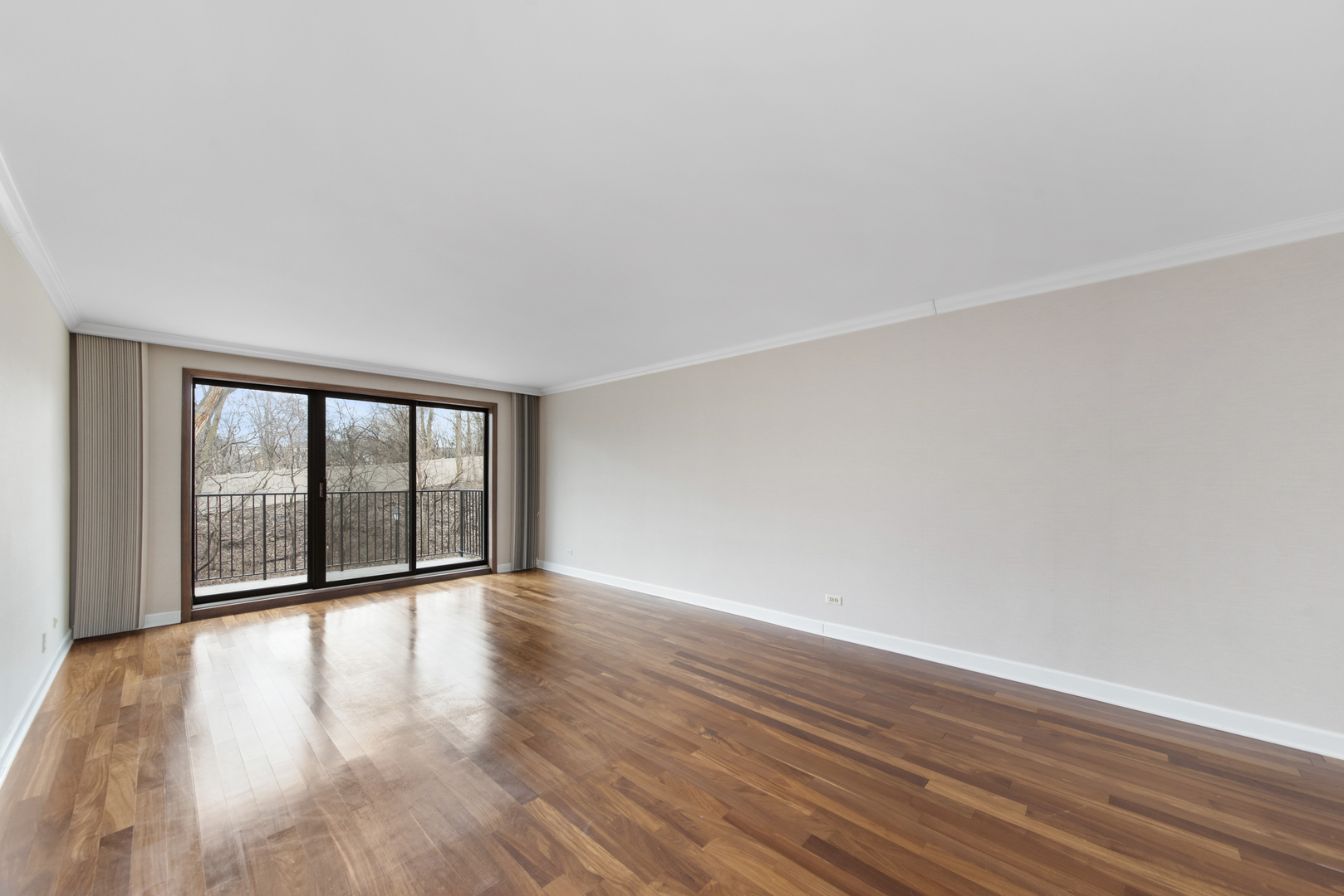 1-s150 Spring Road, Unit 2E Oak Brook, IL 60181 - Photo 8 of 22 a view of an empty room with wooden floor and a window