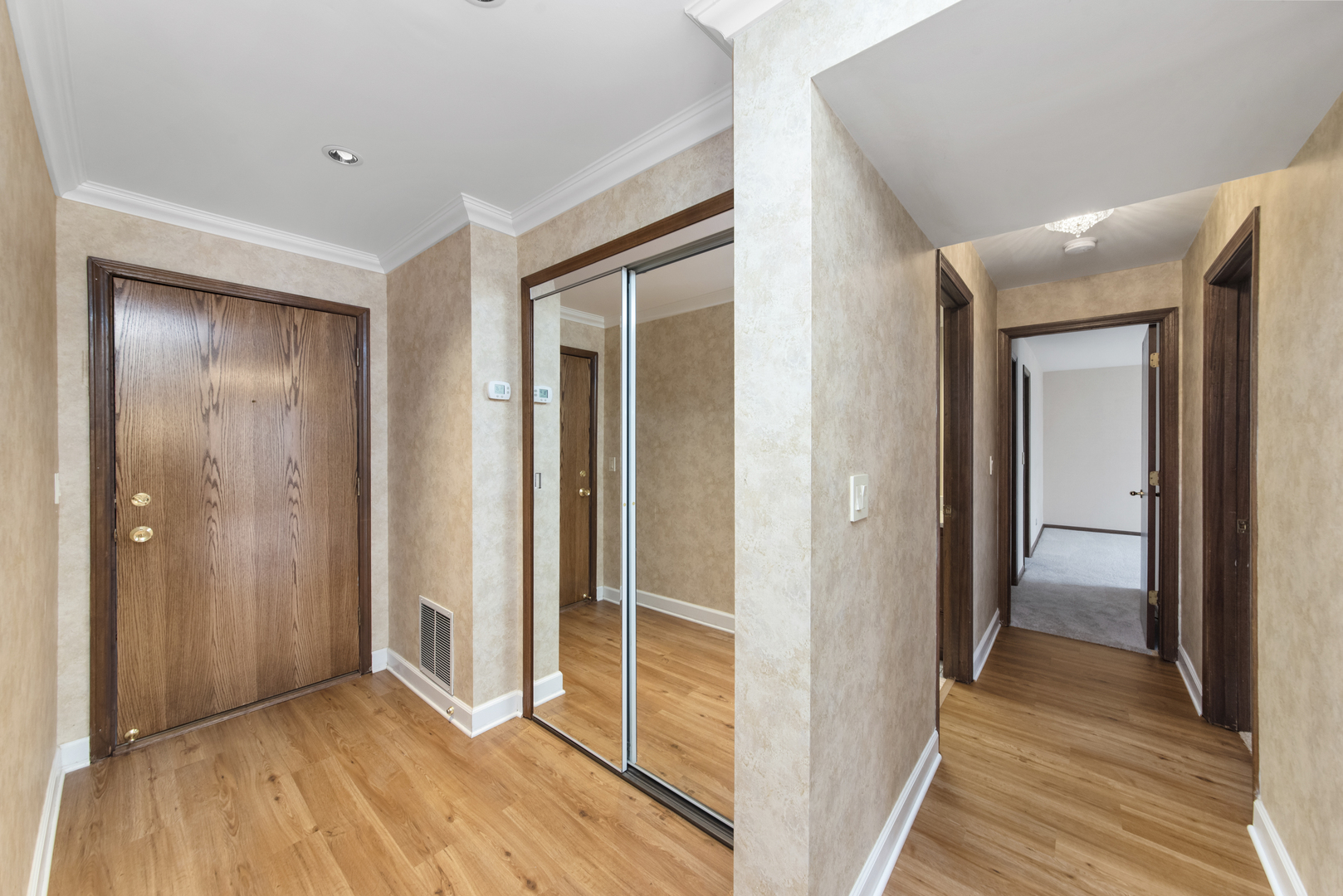 1-s150 Spring Road, Unit 2E Oak Brook, IL 60181 - Photo 10 of 22 a view of a hallway with wooden floor and closet