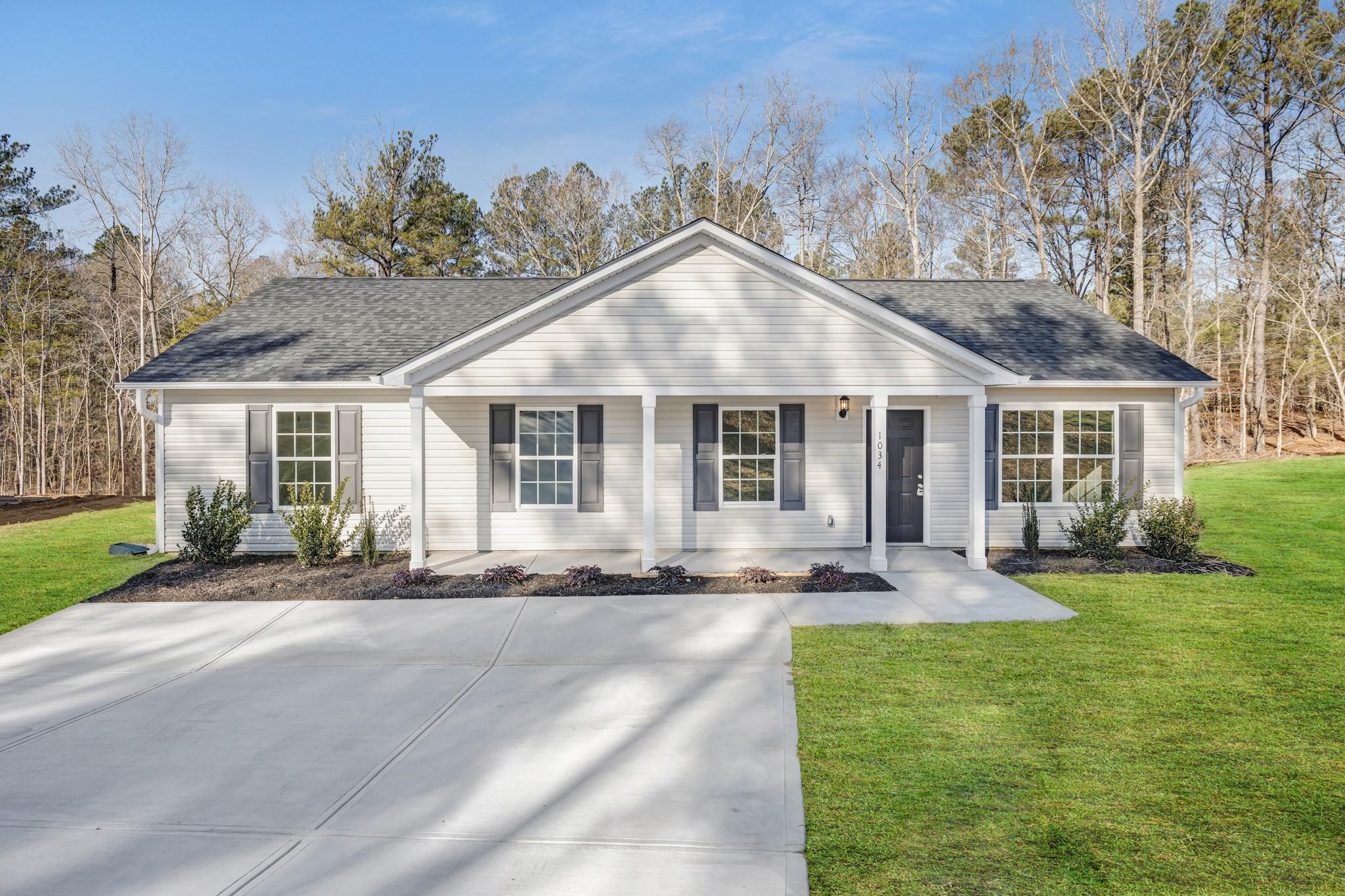a front view of a house with a yard and porch