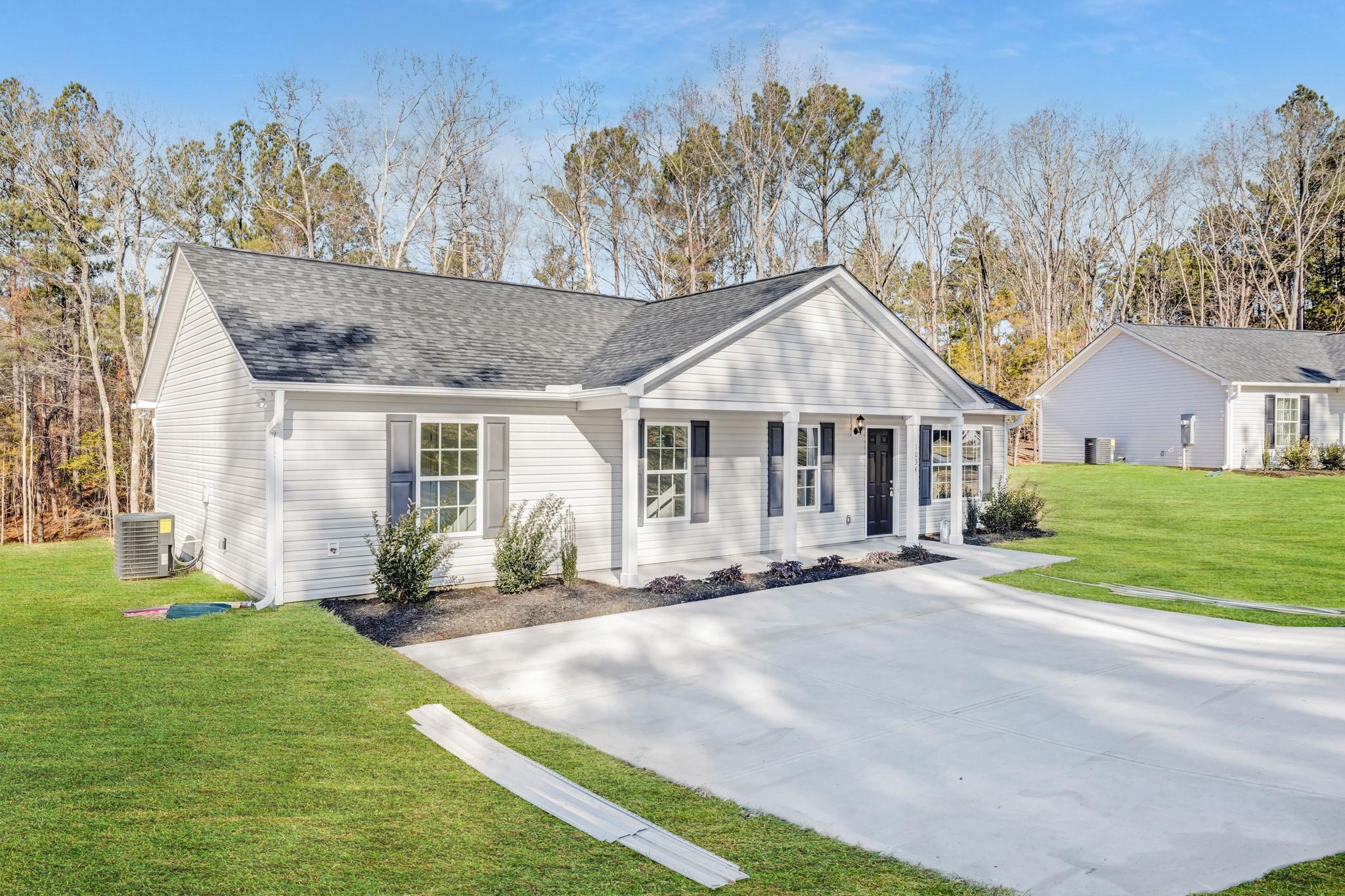 1076 Westminster Drive Lancaster, SC 29720 - Photo 19 of 19 a front view of a house with a yard and trees