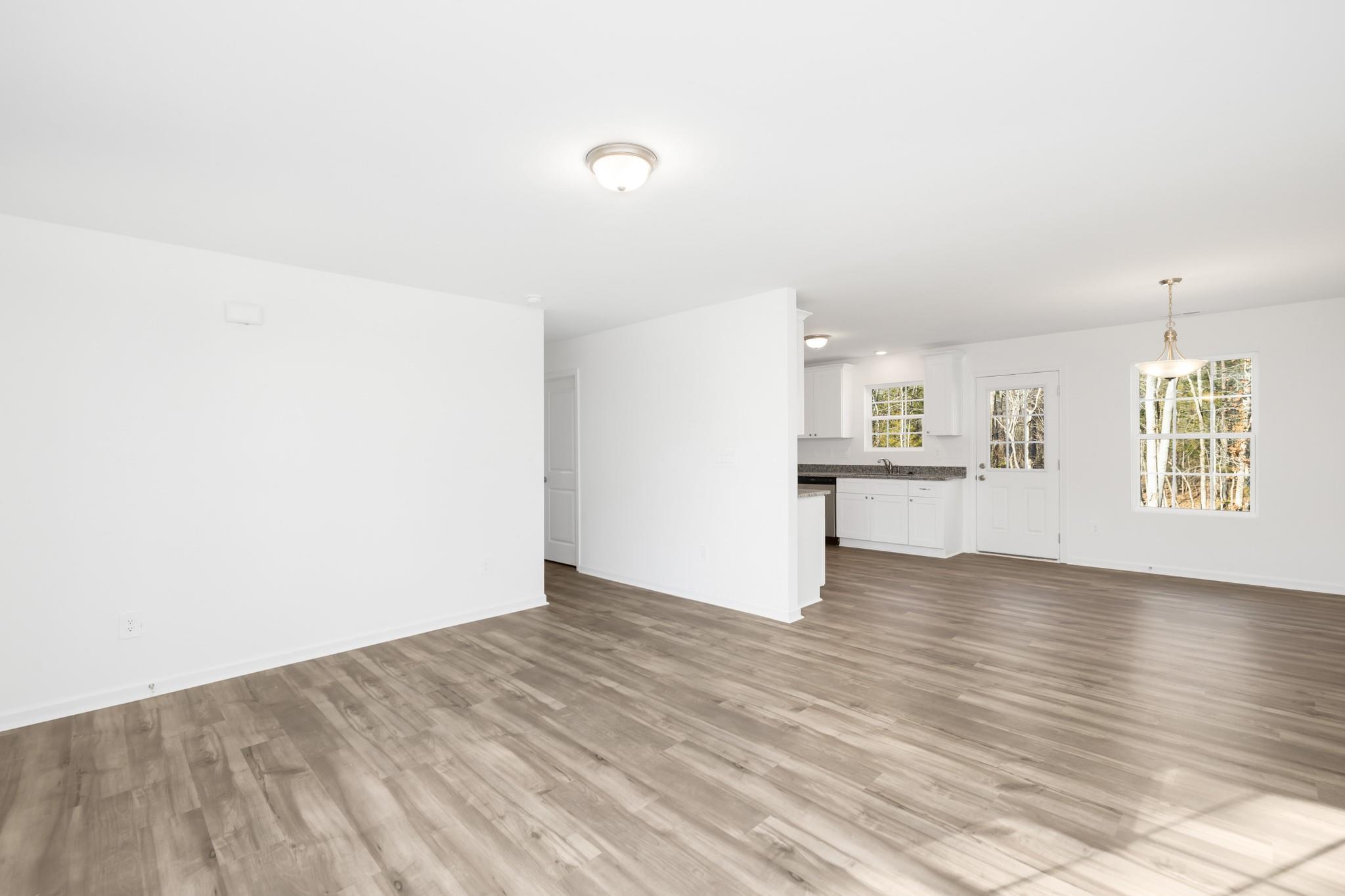 1076 Westminster Drive Lancaster, SC 29720 - Photo 2 of 19 a view of an empty room with wooden floor and a window