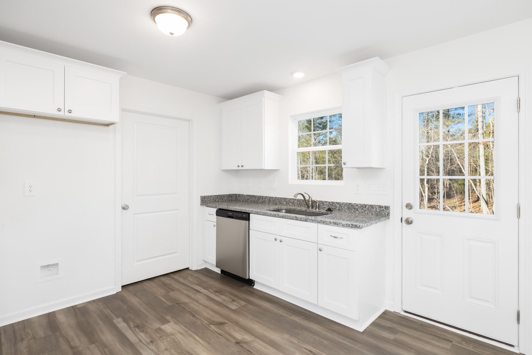 1076 Westminster Drive Lancaster, SC 29720 - Photo 4 of 19 a kitchen with granite countertop a sink and a stove top oven