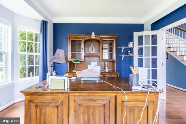 a kitchen with stainless steel appliances granite countertop a stove top oven a sink dishwasher a dining table and chairs with wooden floor