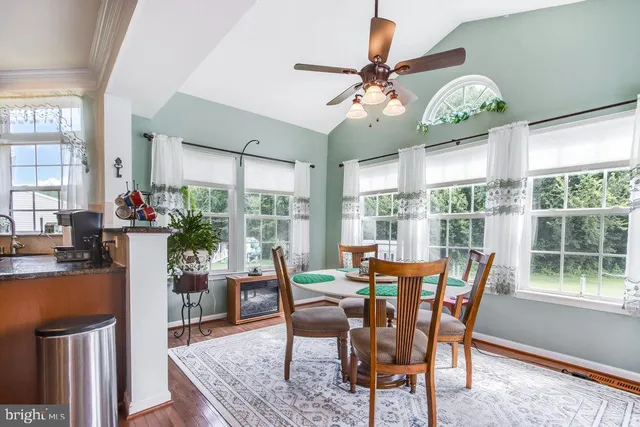a view of a hallway with wooden floor and stairs