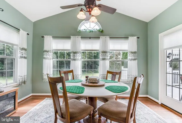 a view of a hallway with wooden floor and stairs