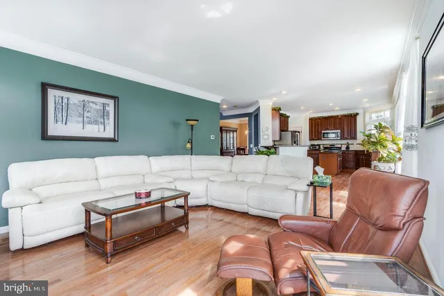 a living room with a couch and a wooden floor