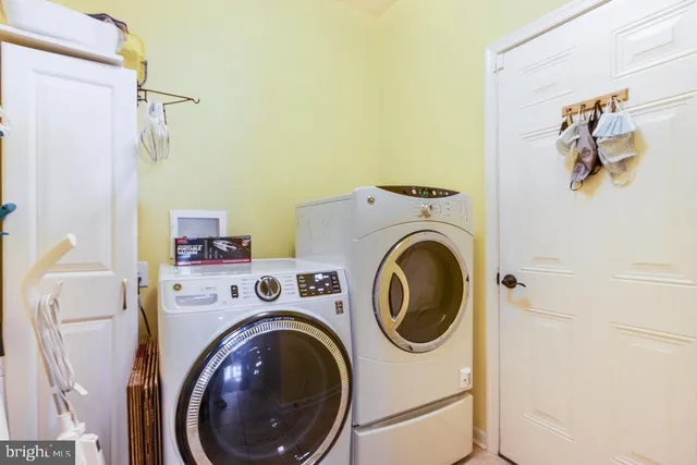 a bathroom with a granite countertop double vanity sink a mirror and a shower