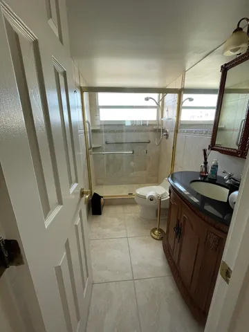a bathroom with a toilet sink shower and mirror