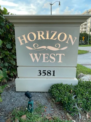 a view of outdoor space with signage and flags