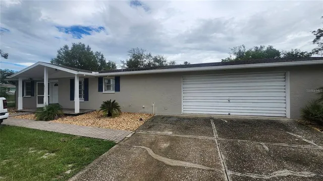 a backyard of a house with yard and barbeque oven