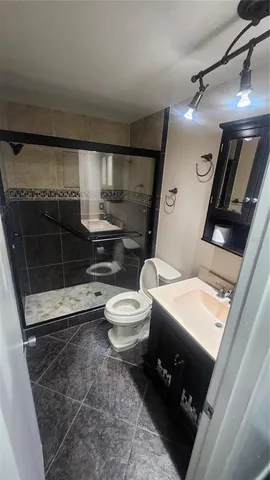 a bedroom with a bed and a night stand