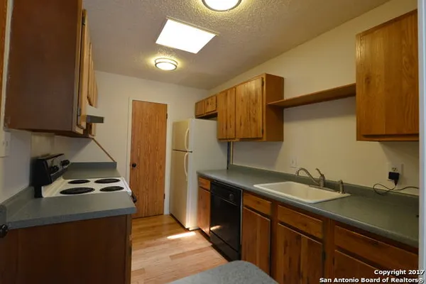 a kitchen with a sink appliances and cabinets