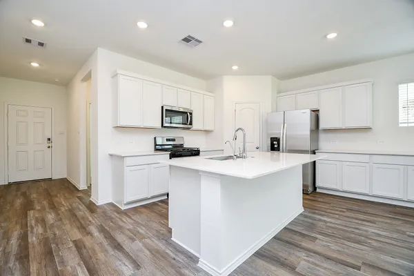 a kitchen with white cabinets and white appliances