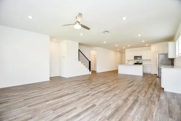 a view of kitchen with sink and refrigerator