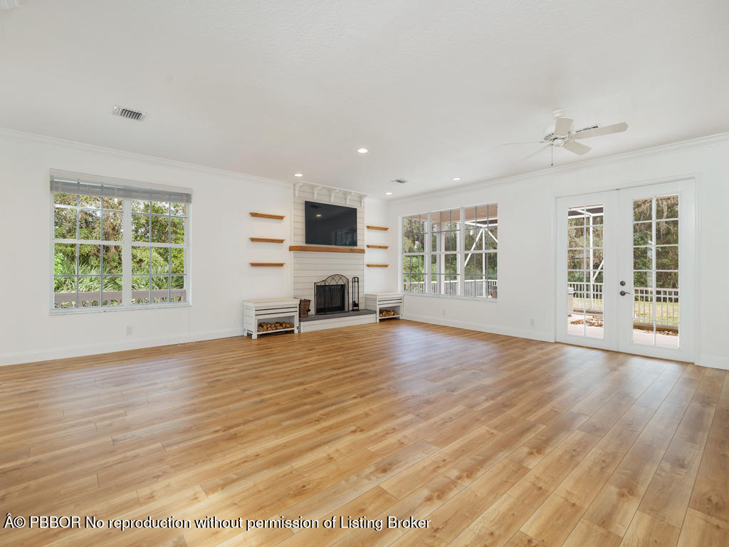 1001 Southeast Ranch Road Northeast Jupiter, FL 33478 - Photo 6 of 32 a view of livingroom with furniture window and wooden floor