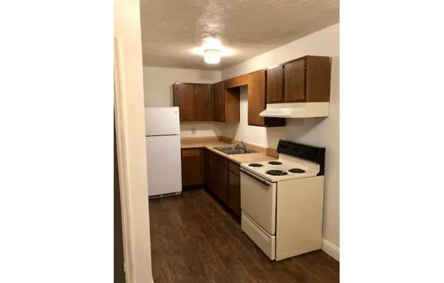 a kitchen with a stove cabinets and a refrigerator