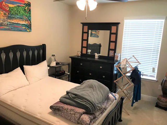 a bedroom with a bed and a chandelier