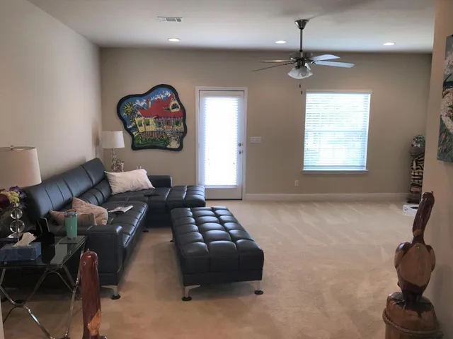 a livingroom with workspace window and a couch