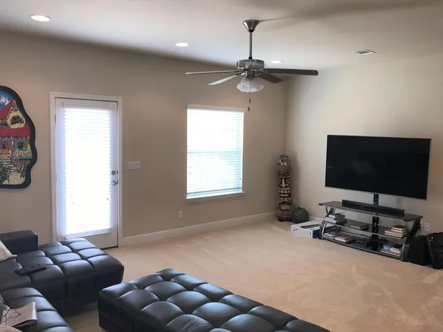 a living room with furniture a couch and a window