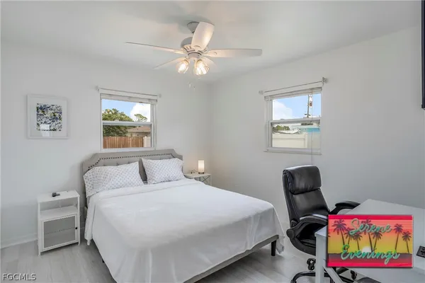 a bedroom with a bed a couch and a window