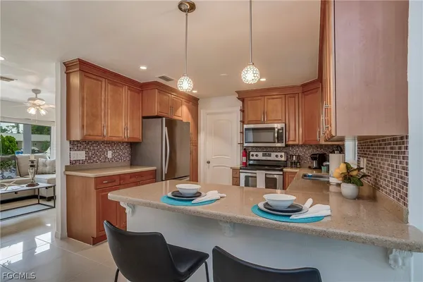 a kitchen with a sink appliances and cabinets