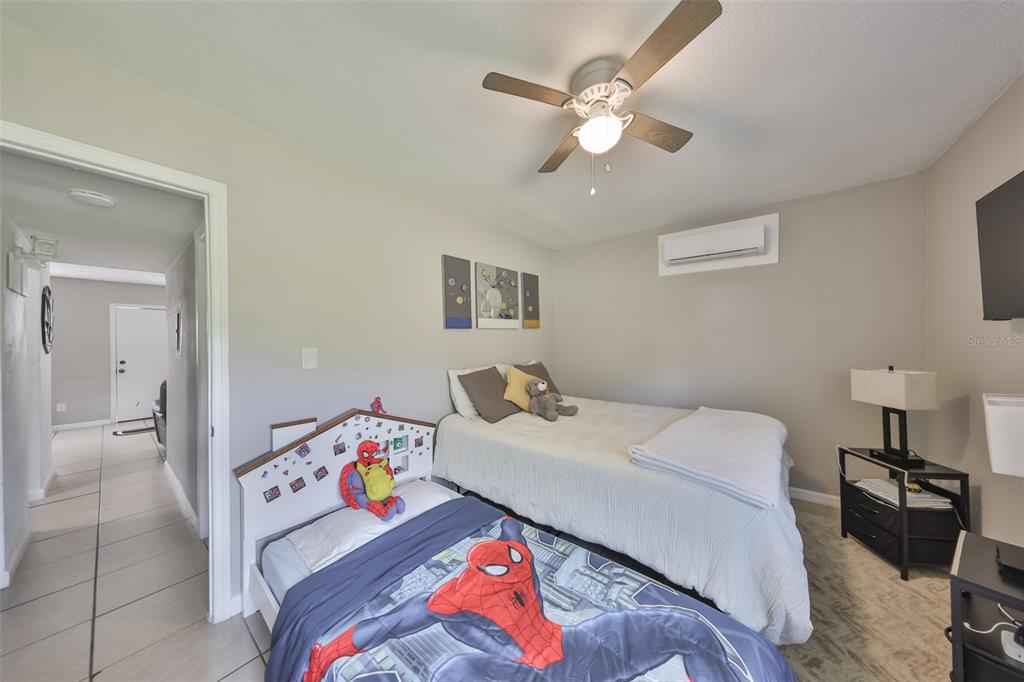 11708 Balm Riverview Road Riverview, FL 33569 - Photo 22 of 37 a bedroom with a bed and a chandelier