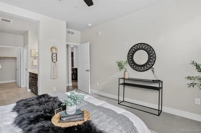 a living room with furniture and a mirror